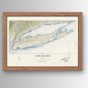 May include: A framed map of Long Island, New York, with a detailed topographical view. The map features shades of green, blue, and tan, with the text "LONG ISLAND" at the bottom. The frame is made of wood.