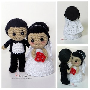 May include: Crocheted bride and groom dolls. The groom wears a black tuxedo with a white shirt and the bride wears a white dress and veil, holding a red bouquet. The dolls have black hair and smiling faces. The image includes the text "GStore".