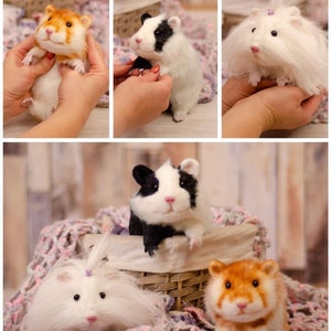 May include: Four handmade needle felted hamster figurines. Two are brown and orange, one is black and white, and one is white with a long white tail. The hamsters are sitting on a pink and white blanket and in a wicker basket.