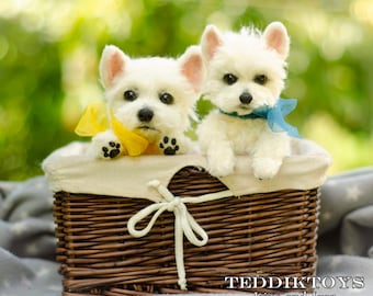 May include: Two white stuffed toy dogs sitting in a wicker basket. The dog on the left has a yellow bow and the dog on the right has a blue bow. The basket is lined with a white fabric.