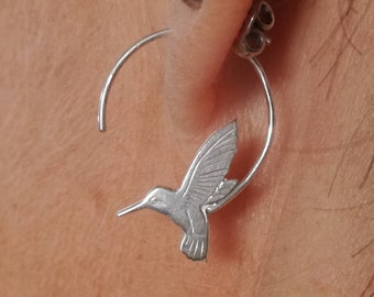 Sterling silver swooping hummingbird hoop earrings