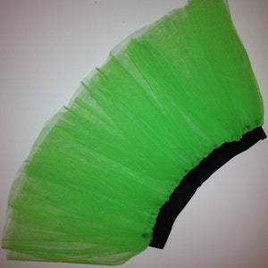 May include: A bright green tulle skirt with a black elastic waistband.