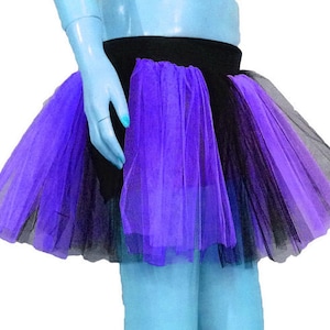 May include: A purple and black tulle tutu skirt with a black waistband. The skirt is layered and has a soft, flowing texture.
