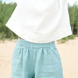 May include: A pair of light blue linen shorts with an elastic waistband.