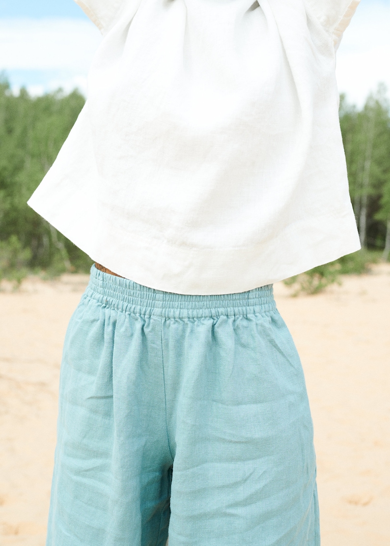 May include: A pair of light blue linen shorts with an elastic waistband.