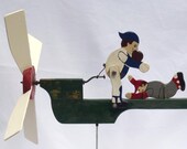 A whirligig with two baseball players. One tries to tag the other out as the blade turns. (Offers Considered)