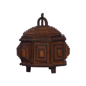 A small octagonal tramp art box with alternating shades of cigar box wood, with an intricate finial and three feet. (Offers Considered)