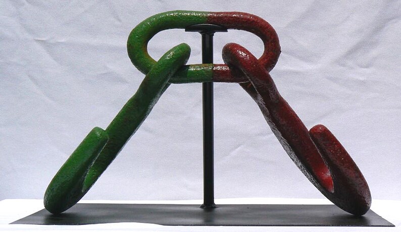 Movable metal sculpture made of two huge old iron hooks connected through a link Offers Considered Great Paint and Color.