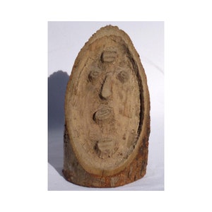 An  odd Folk Art relief carving of a face. Unusual carved head or face. A folky Wood carving.