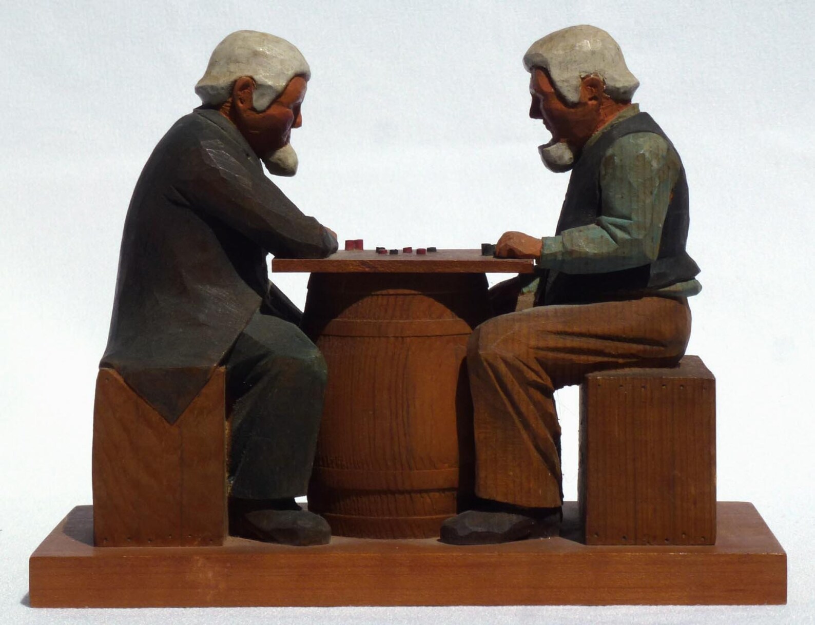 Detailed Folk Art carving of 2 men playing checkers signed