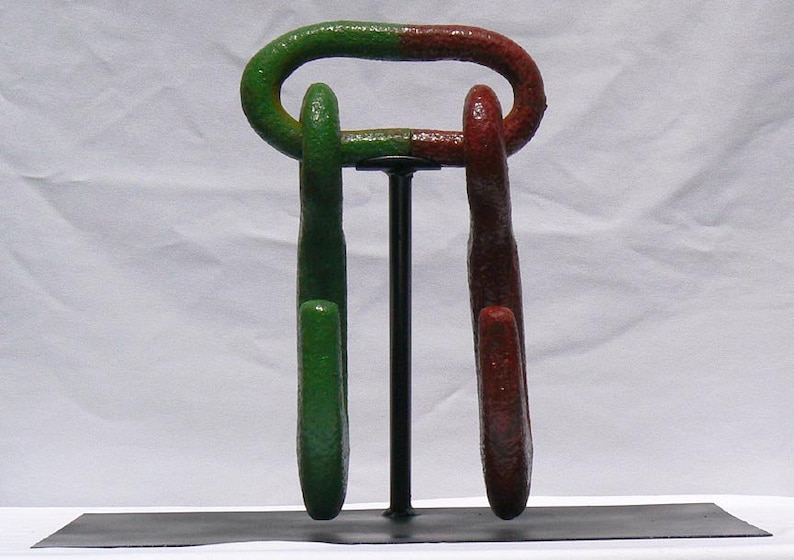 Movable metal sculpture made of two huge old iron hooks connected through a link Offers Considered Great Paint and Color.
