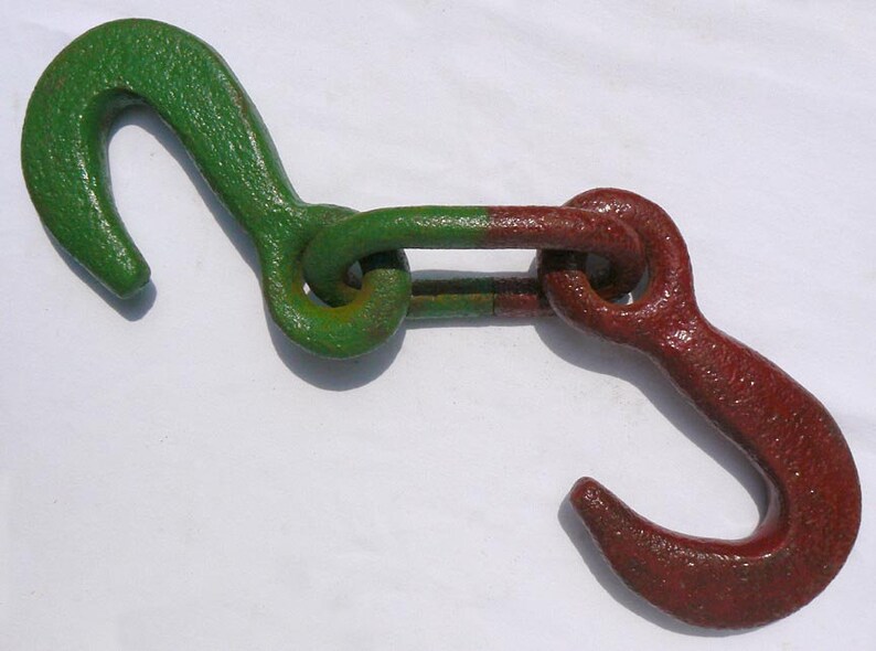Movable metal sculpture made of two huge old iron hooks connected through a link Offers Considered Great Paint and Color.