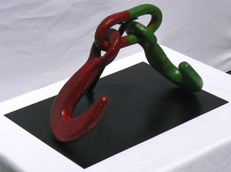 Movable metal sculpture made of two huge old iron hooks connected through a link Offers Considered Great Paint and Color.
