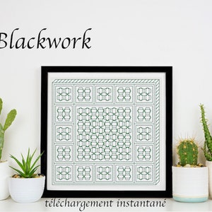 May include: A black and white framed print featuring a geometric pattern in green. The print is titled "Blackwork" and has the text "téléchargement instantané" below it. The print is displayed on a shelf with potted succulents.