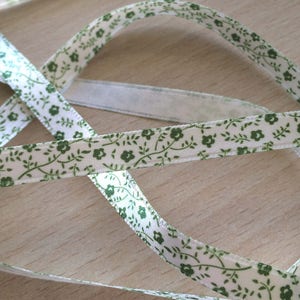 pretty ecru satin ribbon with green floral pattern