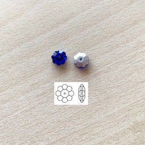 May include: Two blue flower-shaped crystal beads with a silver backing. A line drawing of the bead shape is shown below.