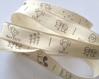 decorative ribbon: "pretty girl" brown on ecru background