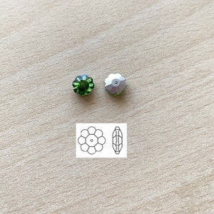 May include: Two green flower-shaped glass beads with a silver-coloured bead next to them. A diagram of the bead shape is shown below.