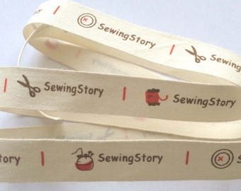 decorative ribbon: brown stitching on ecru background