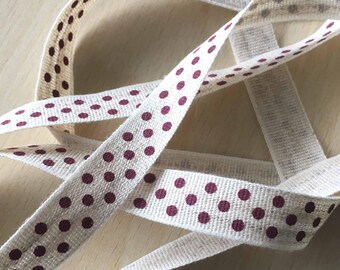 decorative ribbon: "burgundy polka dots" on mottled ecru background