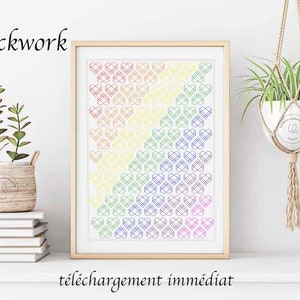 May include: A digital download of a blackwork pattern featuring a rainbow of hearts. The pattern is framed and displayed on a white wall with a plant hanging in the background. The text "Blackwork" is displayed above the frame and "téléchargement immédiat" is displayed below the frame.