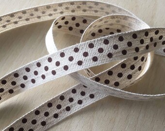 decorative ribbon: "brown polka dots" on mottled ecru background