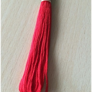 May include: A spool of red embroidery floss with the number 666 printed on the label.