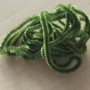 Op de afbeelding: Een bundel groene pijpenragers, ook wel chenille-stengels genoemd, zijn in een willekeurig patroon gedraaid.