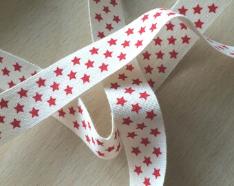 decorative ribbon: "red stars" on ecru background