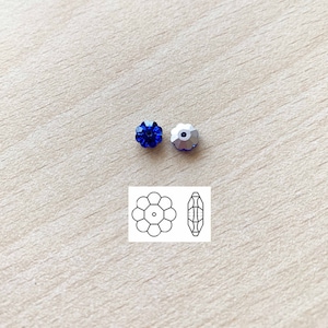 May include: Two blue crystal flower beads with a silver finish. The beads are shown next to a line drawing of the bead.