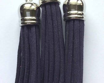 on tip metal ring with black/purple suede tassel
