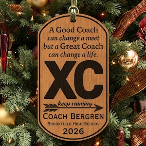 May include: A rectangular wooden ornament with rounded corners featuring the engraved text: A Good Coach can change a meet but a Great Coach can change a life. XC, keep running, Coach Bergren, Brookfield High School, and the year 2026.