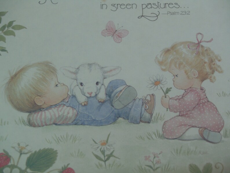 May include: A vintage illustration of two children in a field with a lamb. The boy is lying on his back with the lamb on his stomach. The girl is standing and holding a daisy. The text "in green pastures... -Psalm 23:2" is in the top right corner of the image.