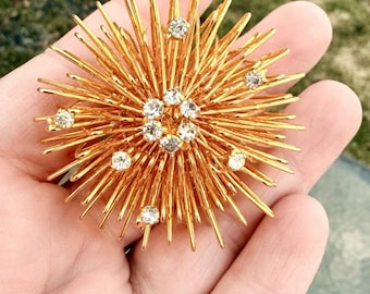 Broche vintage MCM ATOMIC con alambre dorado y diseño tridimensional de estrella Sputnik.