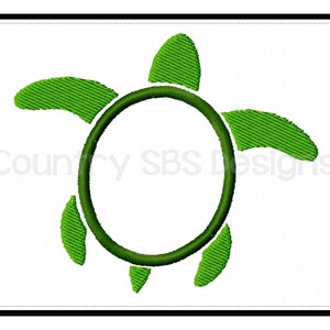 May include: Green embroidered turtle design with a circular outline. The turtle has a simple design with a rounded body and four legs.