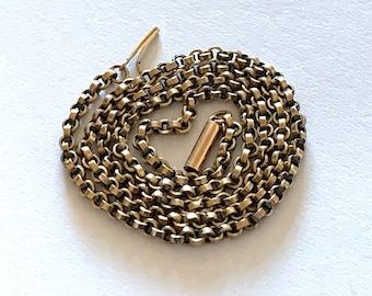 May include: A gold chain necklace with a lobster clasp closure.