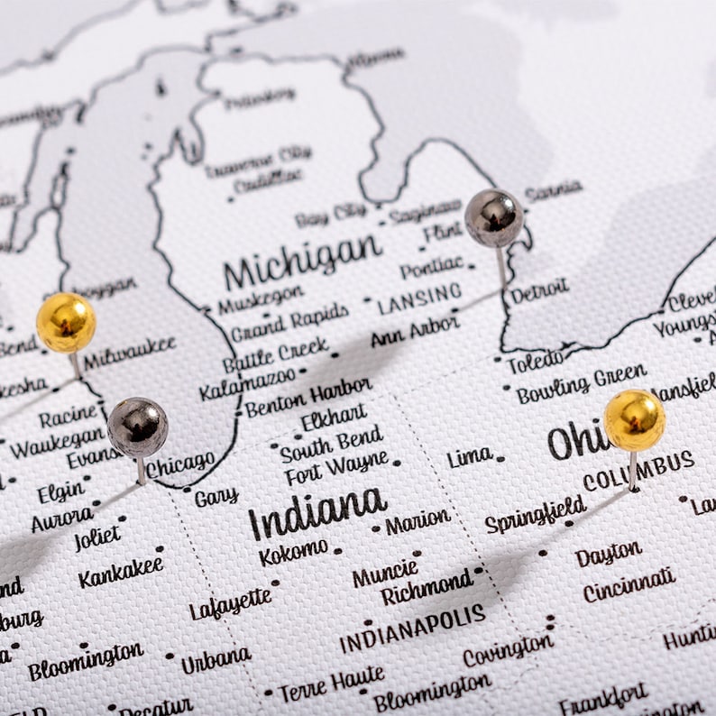 May include: A map of the United States with push pins marking the locations of Chicago, Illinois, Columbus, Ohio, and Detroit, Michigan.
