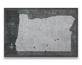 May include: A vintage-style map of Oregon with a black background and white lines showing roads and cities. The map is surrounded by a black border and includes the names of surrounding states.