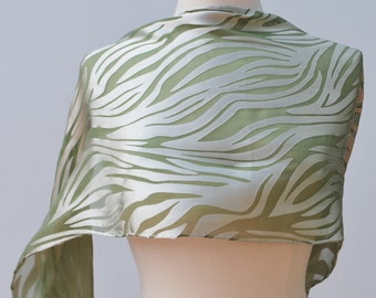 Hand dyed silk and rayon scarf. Soft green silk background with silvery designs.