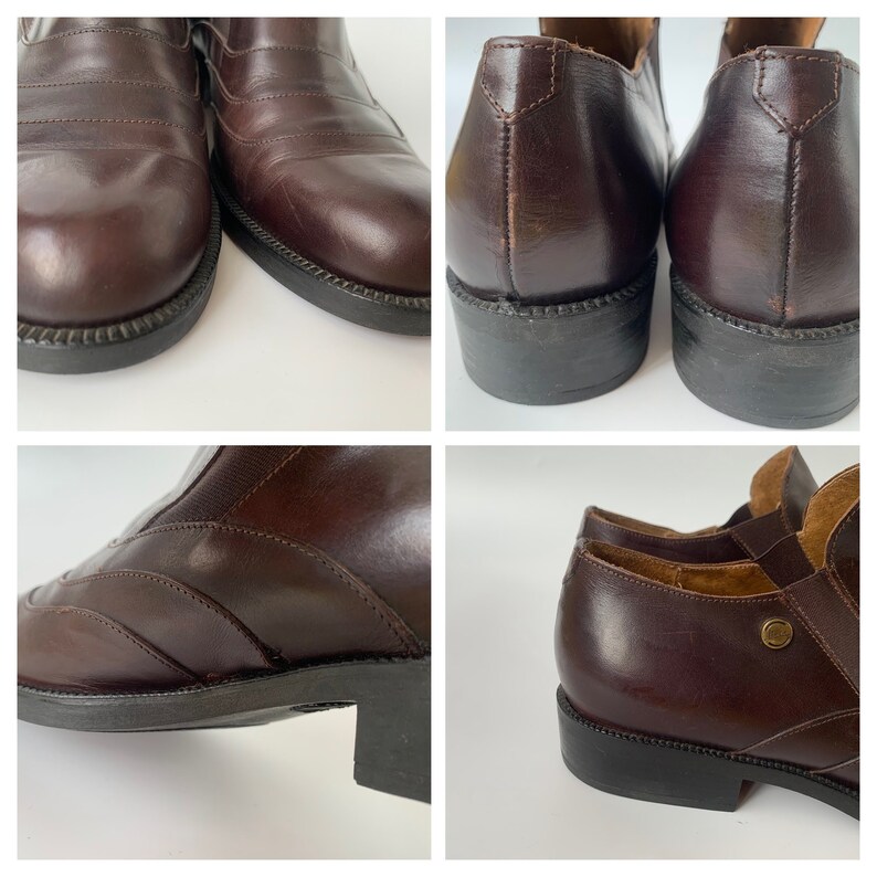 K&ouml;nnte beinhalten: Ein Paar braune Lederstiefeletten mit spitzer Zehenpartie und niedrigem Absatz. Die Stiefeletten haben einen Rei&szlig;verschluss an der Innenseite des Kn&ouml;chels und einen dekorativen Riemen &uuml;ber dem Fu&szlig;r&uuml;cken.