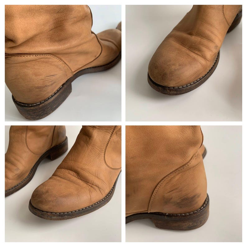 May include: A pair of brown leather ankle boots with a slouchy design. The boots have a rounded toe and a low heel. The leather is distressed and has a worn look.