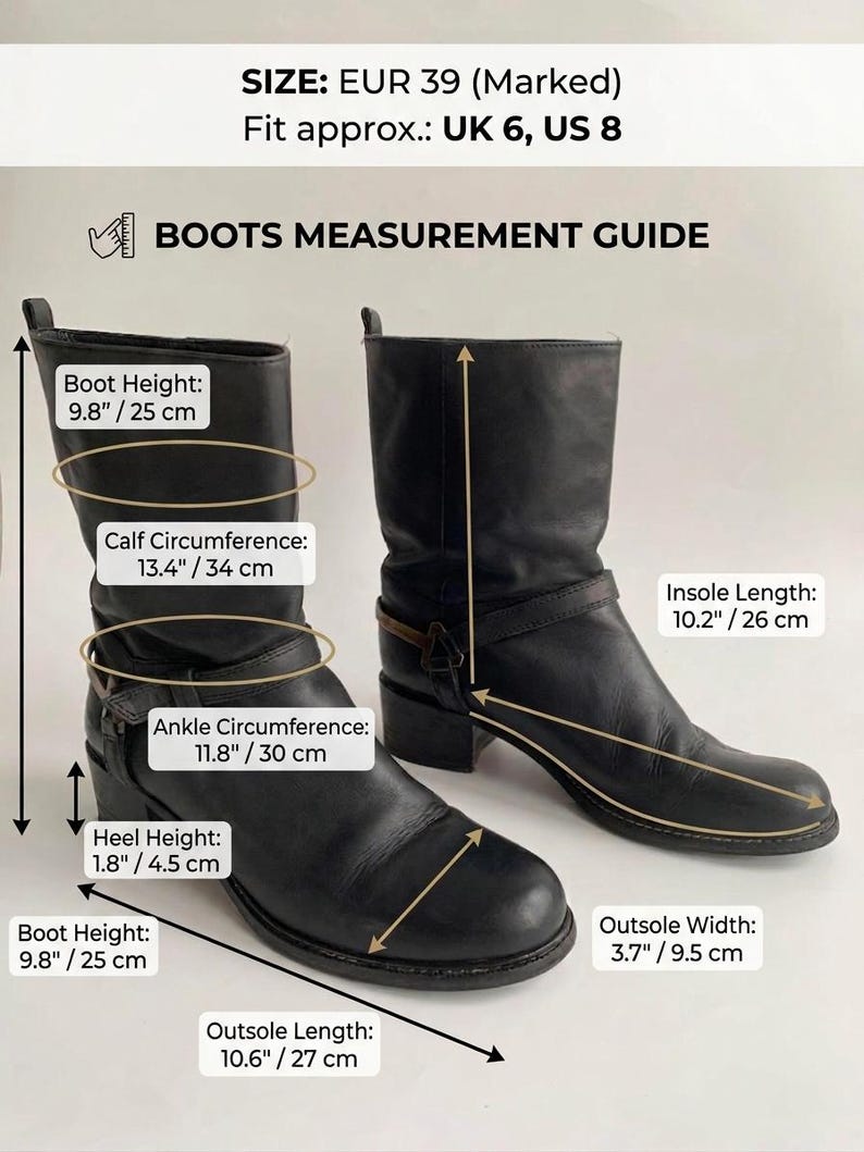 May include: A pair of black leather boots with a low heel and a strap detail. The image includes a measurement guide with text: SIZE: EUR 39 (Marked) Fit approx.: UK 6, US 8. Boot Height: 9.8 inches, Calf Circumference: 13.4 inches, Ankle Circumference: 11.8 inches.