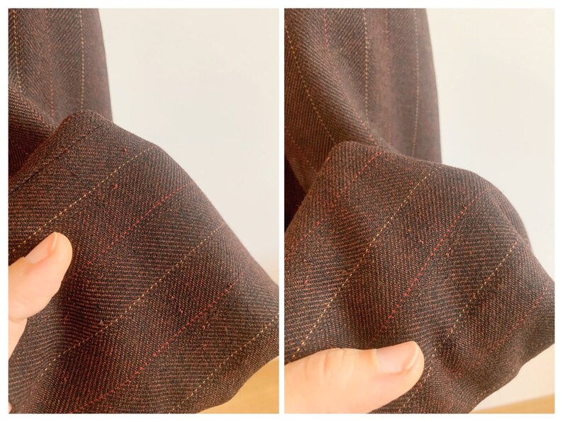 May include: Close-up of a brown and red striped fabric with a subtle herringbone pattern. The fabric is soft and has a smooth texture.