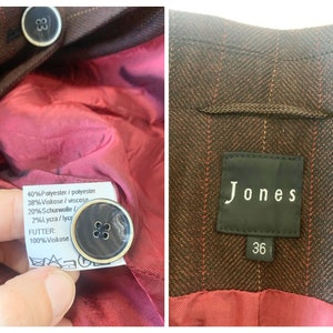 May include: A brown and red striped blazer with a black label that says "Jones" and a size 36 tag. The blazer is made of 40% polyester, 38% viscose, 20% wool, and 2% lycra. The lining is 100% viscose.