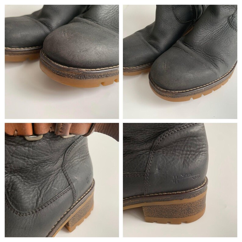 May include: A pair of black leather ankle boots featuring a textured surface, a rounded toe, and a thick gum-coloured lug sole. The boots include a brown leather strap detail near the top and a small embossed logo on the outer side of the heel.