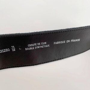 May include: Black leather belt with embossed text including "CROUTE DE CUIR DOUBLE SYNTHETIQUE" and "FABRIQUE EN FRANCE". The belt is 75 cm wide and 30 inches long. The belt has the number "035280" printed on it.