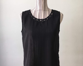 May include: A black sleeveless top with a crocheted neckline.