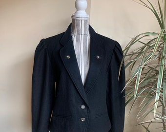 May include: A black blazer with a single-breasted closure and three buttons. The blazer has a slightly fitted silhouette and features puffed shoulders.
