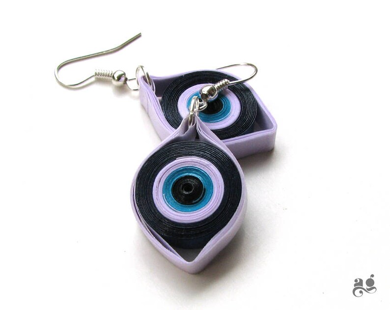 May include: A pair of lavender and black paper quilled earrings with a blue and black eye design.