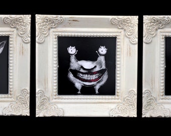 May include: Three framed black and white illustrations of cartoon creatures with exaggerated features. The first creature has large ears and a wide grin. The second creature has a large, toothy smile and appears to be a monster. The third creature has large eyes and a red, smiling mouth.